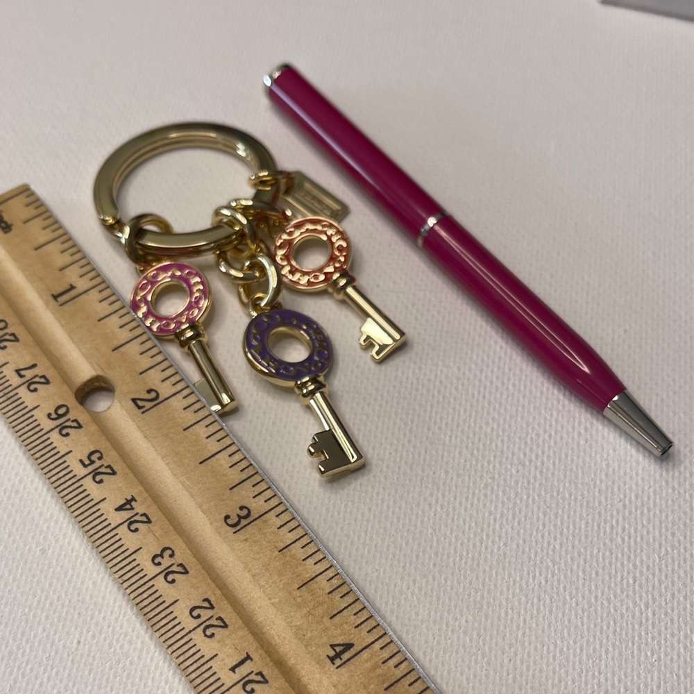 Gold Coach Keychain with Colorful Keys and a Pink Coach Pen - Picture 3 of 5